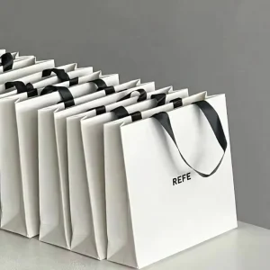 Custom Luxury Gold Foil Matte Embossed Laminated Paper Bag Logo Large Medium White Gift Sturdy Paper Clothing Store Shopping Bag